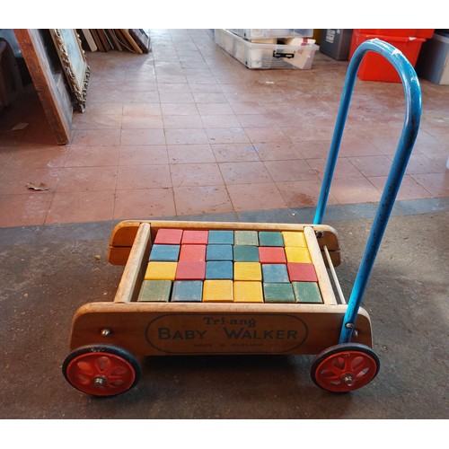 425 - Tri-ang baby walker with twenty-four coloured wooden blocks