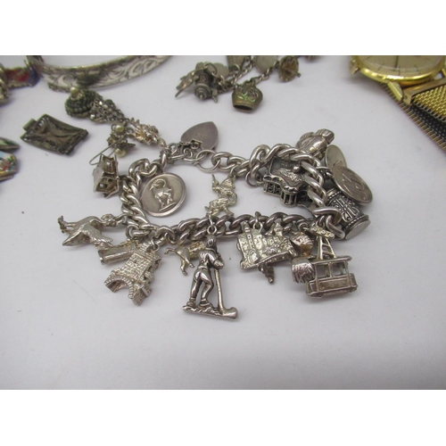19 - Silver charm bracelet with approx. 17 silver and white metal charms, most stamped Sterling, 800, 835... 