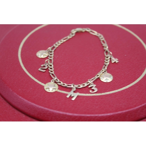 35 - 9ct yellow gold chain link bracelet, clasp stamped 375, with attached yellow metal charms, gross 7.9... 