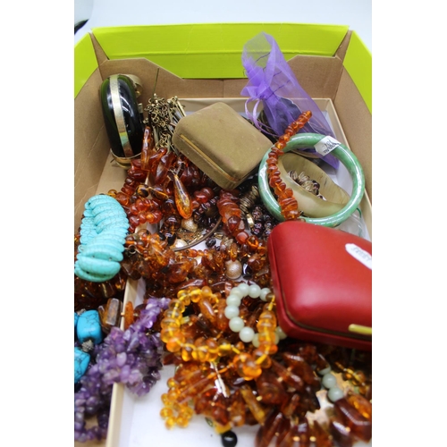 42 - Semi precious jewellery including a carved jade bangle, an amethyst necklace, amber beads and a coll... 