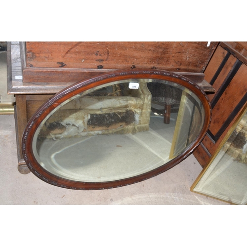 499 - An Edwardian mahogany framed ovel bevelled edge mirror with egg and darts border W89cm X H59cm and a... 