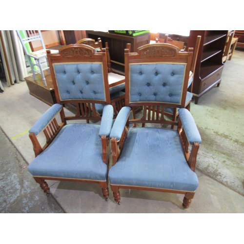 689 - Pair of Victorian walnut framed salon open arm chairs with carved cresting on turned supports with c... 