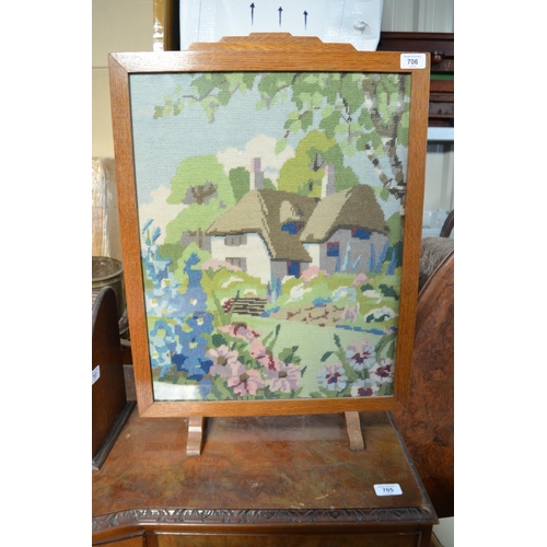 706 - C20th fire screen with an embroidered panel of a countryside thatched cottage W47.5cm X H65.5cm