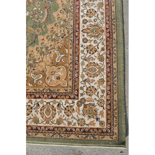 502 - English Manor traditional pattern green ground acrylic rug with central medallion and floral pattern... 