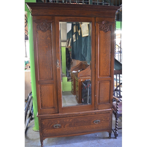 681 - C20th oak wardrobe, mirror door enclosed by carved panels and single drawer on turned supports W130c... 