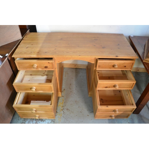 695 - Modern pine kneehole desk, moulded top above six drawers with turn wooden handles on plinth base W14... 