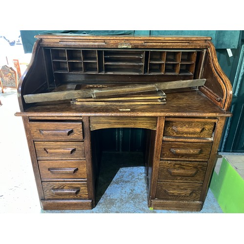 692 - C20th oak roll top desk, serpentine tambour top with fitted interior above pedestal drawers , W122cm... 