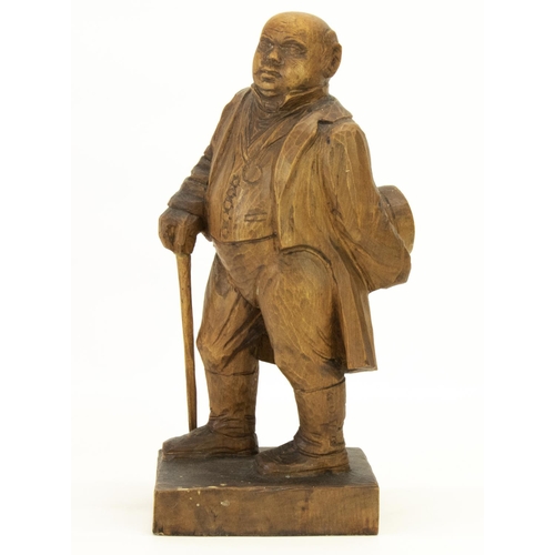 1410 - C20th softwood carved model of a stout Gentleman, standing with hat and walking cane, on square base... 