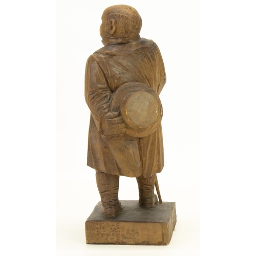 1410 - C20th softwood carved model of a stout Gentleman, standing with hat and walking cane, on square base... 