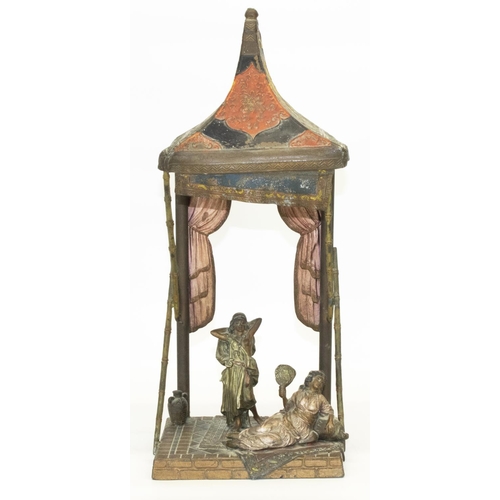 1128 - After Franz Bergman: a painted spelter table lamp in the form of two females on rugs on tiled floor ... 