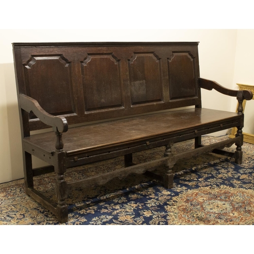 1370 - C18th and later oak settle, raised back with moulded top rail above four fielded panels, solid seat ... 