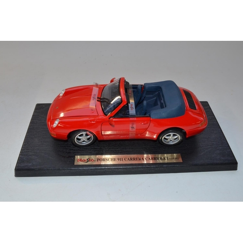33 - Six 1/18 scale boxed diecast Porsche models, 4 Burago and 2 Maisto to include 2x 911 Carrera in yell... 