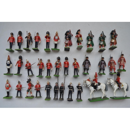 77 - Collection of mostly modern W.Britain's cast metal soldier figures, incl. Highlanders, bandsmen, Bee... 