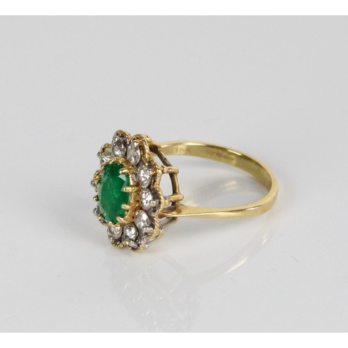 1020 - 18ct yellow gold emerald and diamond cluster ring, the central oval cut emerald surrounded by a halo... 
