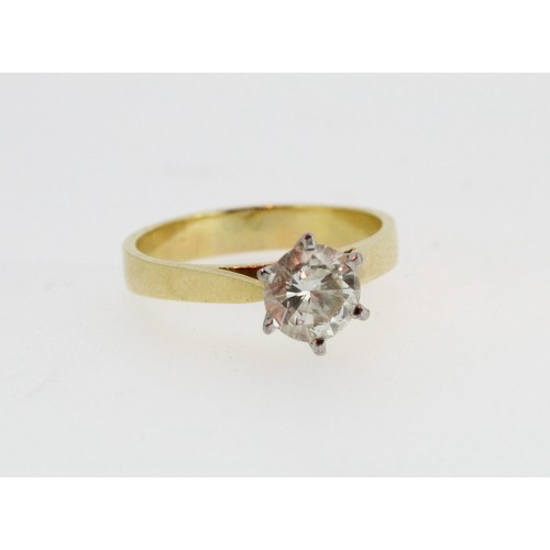 1008 - 18ct yellow gold diamond solitaire ring, the round cut diamond in a white gold Tiffany style setting... 