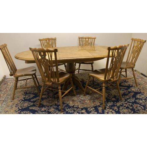 1381 - Stewart Linford Furniture - an oak dining table, oval extending top on baluster turned column and fo... 