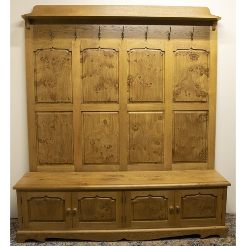 1386 - Stewart Linford Furniture - an oak hallstand, raised back with shelf cornice, seven metal hooks and ... 