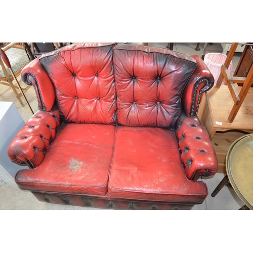 221 - Burgundy leather semi wingback two seater sofa deeply button back W132cm X D77cm X H90cm