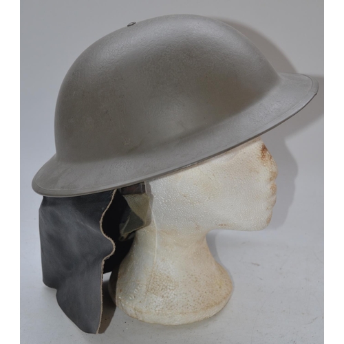 711 - WW2 era British helmet with leather neck protector, stamped on lip 11VB55SLO