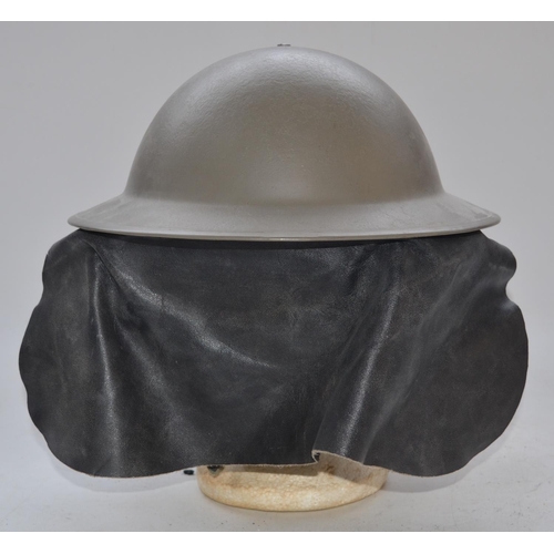 711 - WW2 era British helmet with leather neck protector, stamped on lip 11VB55SLO