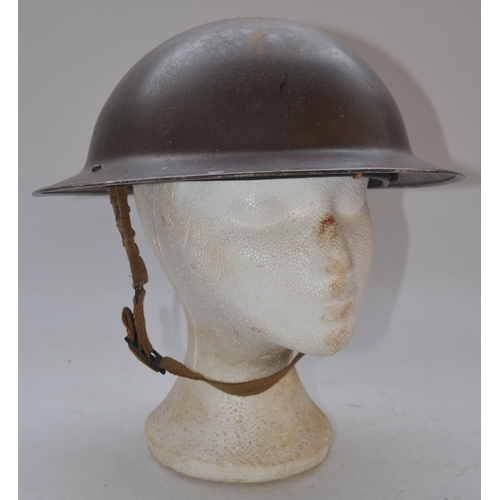 712 - WW2 era British steel helmet with chinstrap, stamped F&L 1/1939