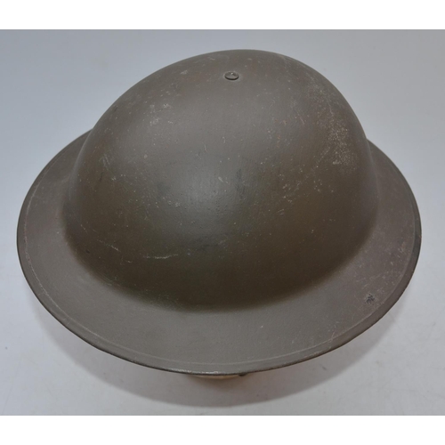 713 - Wartime British steel helmet with chinstrap, stamped on lip B56 1SLO