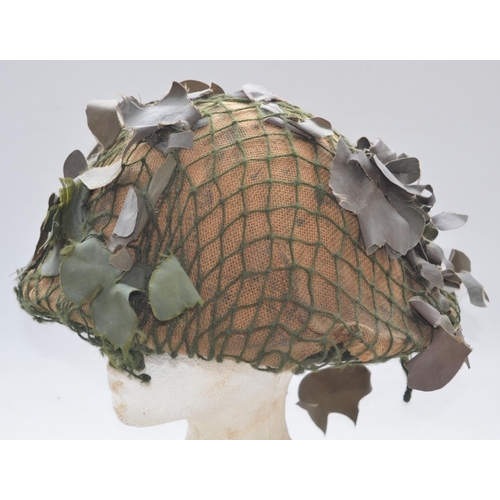 720 - WW2 era British Army MkIV Turtle helmet with liner and camouflage netting. No markings visible