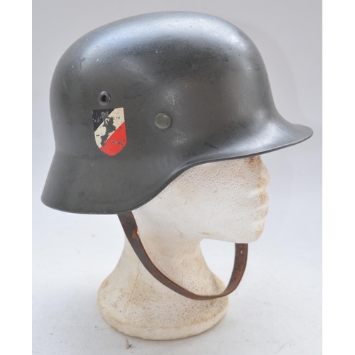 723 - WW2 German helmet with leather liner and chinstrap. Stamped 995 with users names written on liner. P... 