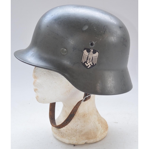 723 - WW2 German helmet with leather liner and chinstrap. Stamped 995 with users names written on liner. P... 