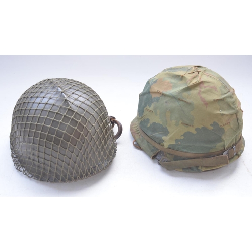 724 - US Army Vietnam era M1 steel helmet with liner and chinstrap and a repainted hard plastic Belgian ri... 