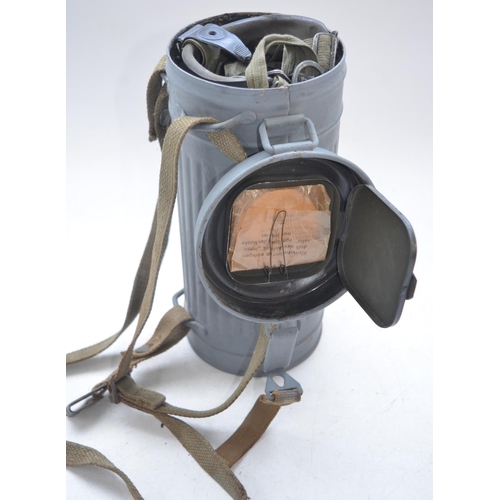 726 - Three post war German gas mask cannisters with gas masks, no cartridges or spare lenses