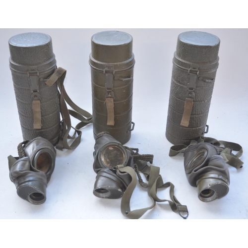 726 - Three post war German gas mask cannisters with gas masks, no cartridges or spare lenses