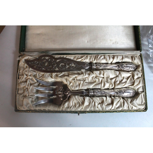 137 - Cased set of fish servers with pierced and engraved blades and white metal repousse handles, L29.5cm... 