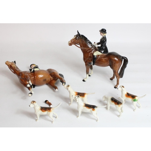 229 - Two Beswick Huntswoman on brown horses (1 A/F) and five hounds