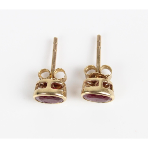 24 - 9ct yellow gold stud earrings set with oval cut rubies, stamped 375, 1.1g
