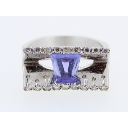 39 - Modernist amethyst and white metal designer dress ring, the tapered baguette cut amethyst suspended ... 