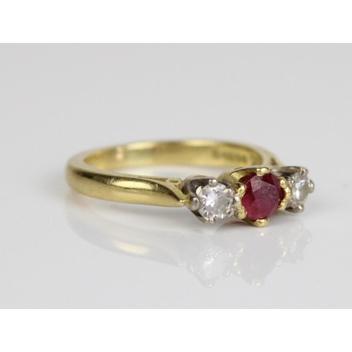 4 - 18ct yellow gold three stone ruby and diamond ring, the central round cut ruby flanked on either sid... 