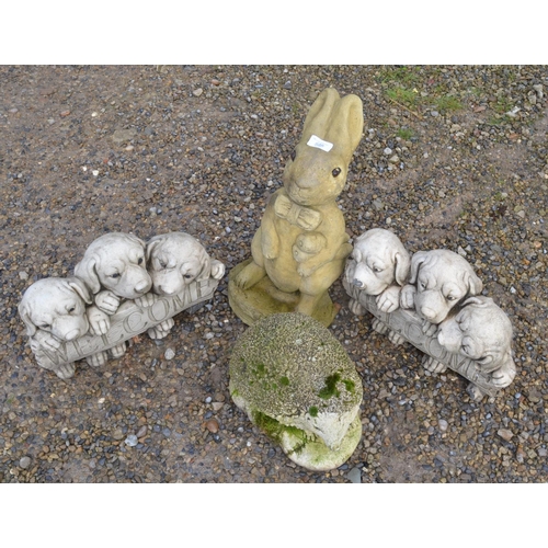 528 - Four reconstituted stone garden ornaments, a rabbit, puppies and a hedgehog