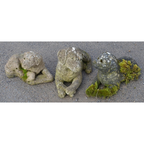 522 - Three reconstituted stone dogs, 1 with damaged front paws