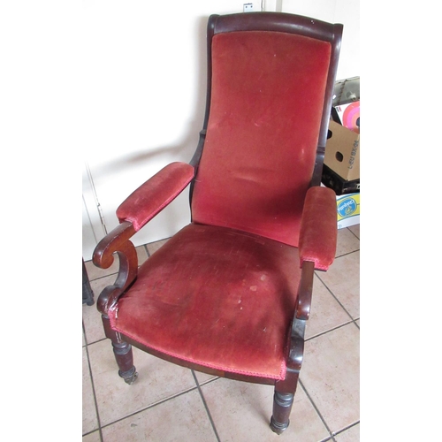 506 - Victorian mahogany framed upholstered open arm chair, turned supports with brass castors, H105cm