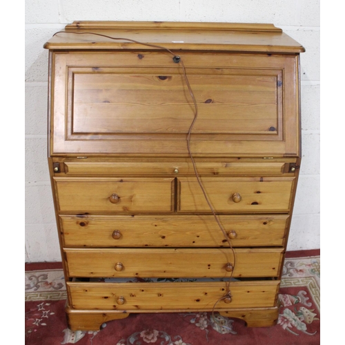 499 - Ducal pine bureau with fall front above two short and three long drawers on plinth base, W86cm D46cm... 