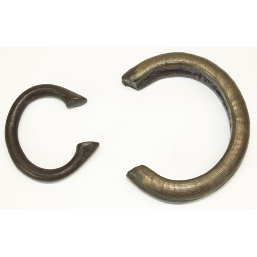 128 - Two West African bronze manilla bracelets, max. 12cm