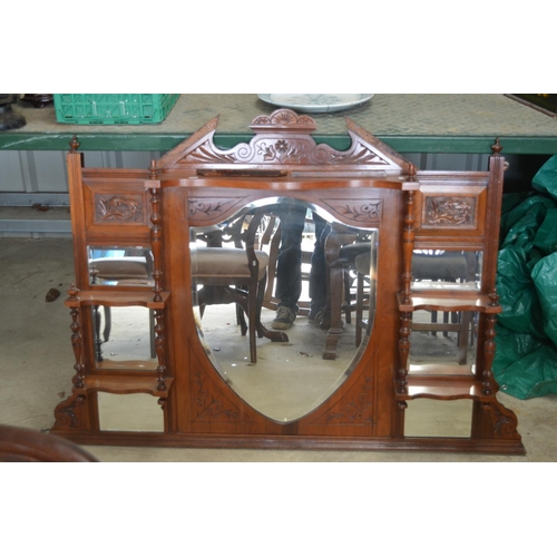 493 - Victorian walnut over mantle, shaped cornice above central shield shaped mirror plate with four shel... 