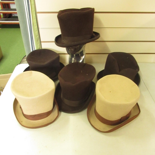 92 - Four brown top hats and two beige top hats (6)