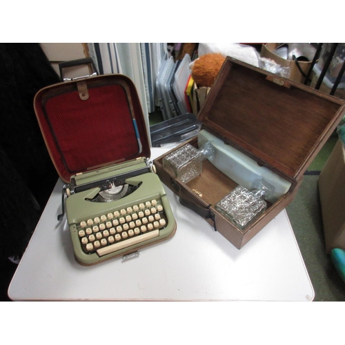 1130 - Cased Bulgarian typewriter and a wood case containing two glass decanters