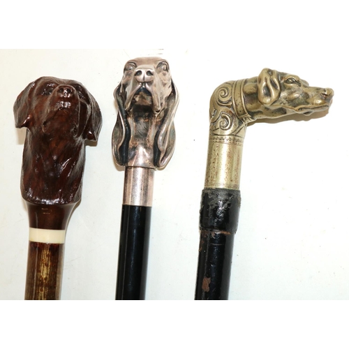 1382 - Ebonised walking stick with cast Hounds head handle, another similar and a stick with carved wooden ... 