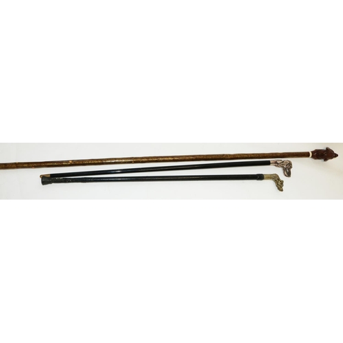 1382 - Ebonised walking stick with cast Hounds head handle, another similar and a stick with carved wooden ... 