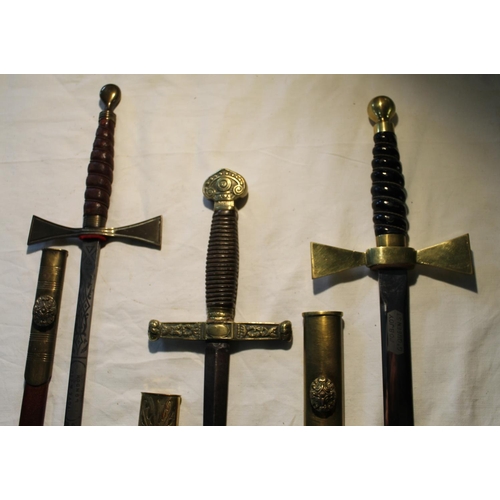 824 - Three decorative Templars swords in original scabbards, one made by Toye & Co Ltd of London, and Pob... 