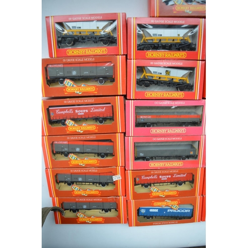 399 - Twenty five boxed Hornby OO gauge goods wagons to include curtain sided vans, open wagons, closed va... 