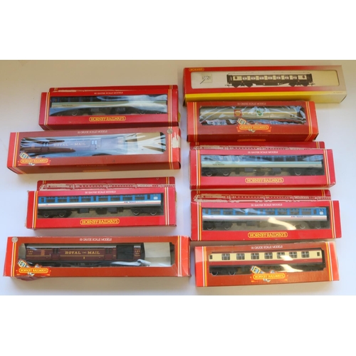 128 - Nine Hornby OO gauge coaches and rolling stock comprising of 2R412 operating mail coach, R442 BR com... 